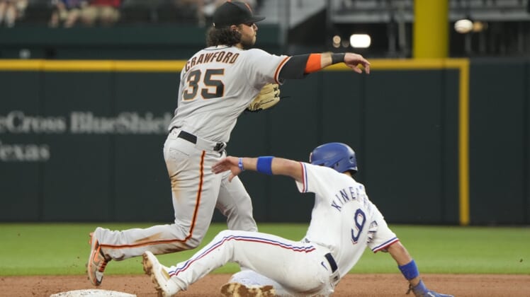 Jun 8, 2021; Arlington, Texas, USA; San Francisco Giants shortstop Brandon Crawford (35) throws to first base after forcing out Texas Rangers shortstop Isiah Kiner-Falefa (9) completing the double play during the third inning at Globe Life Field. Mandatory Credit: Jim Cowsert-USA TODAY Sports