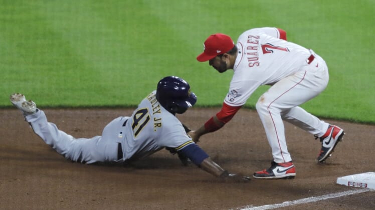 Jun 8, 2021; Cincinnati, Ohio, USA; Milwaukee Brewers center fielder Jackie Bradley Jr. (41) is tagged out at third by Cincinnati Reds third baseman Eugenio Suarez (7) during the seventh inning at Great American Ball Park. Mandatory Credit: David Kohl-USA TODAY Sports