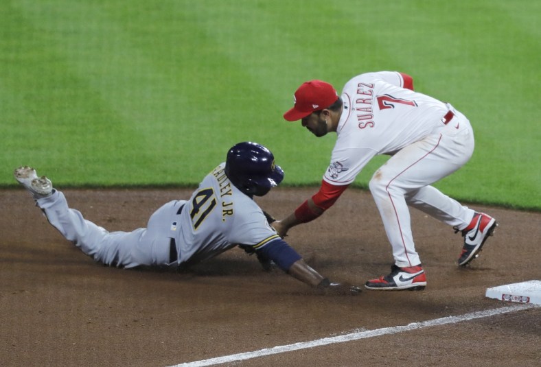 Jun 8, 2021; Cincinnati, Ohio, USA; Milwaukee Brewers center fielder Jackie Bradley Jr. (41) is tagged out at third by Cincinnati Reds third baseman Eugenio Suarez (7) during the seventh inning at Great American Ball Park. Mandatory Credit: David Kohl-USA TODAY Sports
