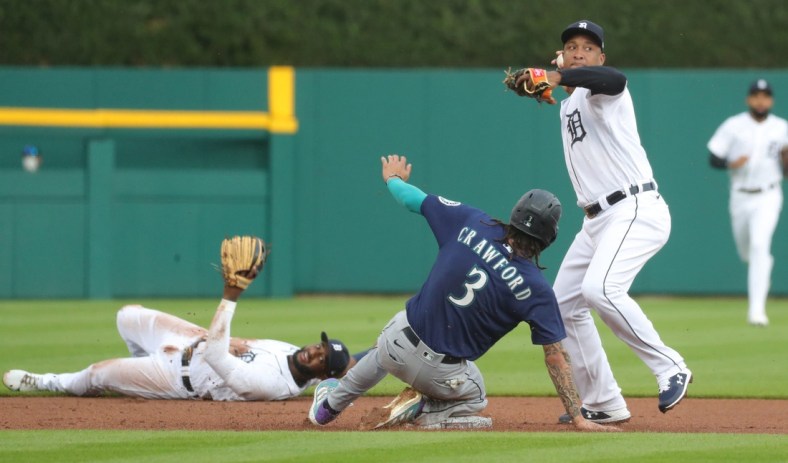Detroit Tigers shortstop Niko Goodrum (28) flip the ball to second baseman Jonathan Schoop (7) for the force out on Seattle Mariners shortstop J.P. Crawford (3) during first inning action Tuesday, June 8, 2021, at Comerica Park in Detroit.

Tigers