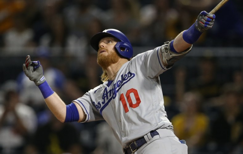 Jun 9, 2021; Pittsburgh, Pennsylvania, USA;  Los Angeles Dodgers third baseman Justin Turner (10) watches his second solo home run of the game clear the fence against the Pittsburgh Pirates during the third inning at PNC Park. Mandatory Credit: Charles LeClaire-USA TODAY Sports