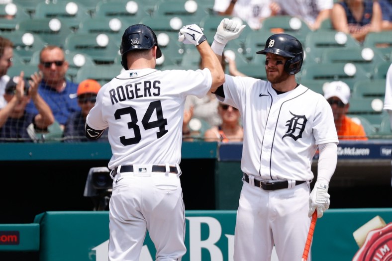 Jun 10, 2021; Detroit, Michigan, USA;  Detroit Tigers catcher Jake Rogers (34) receives congratulations from left fielder Robbie Grossman (8) after he hits a home run in the second inning against the Seattle Mariners at Comerica Park. Mandatory Credit: Rick Osentoski-USA TODAY Sports
