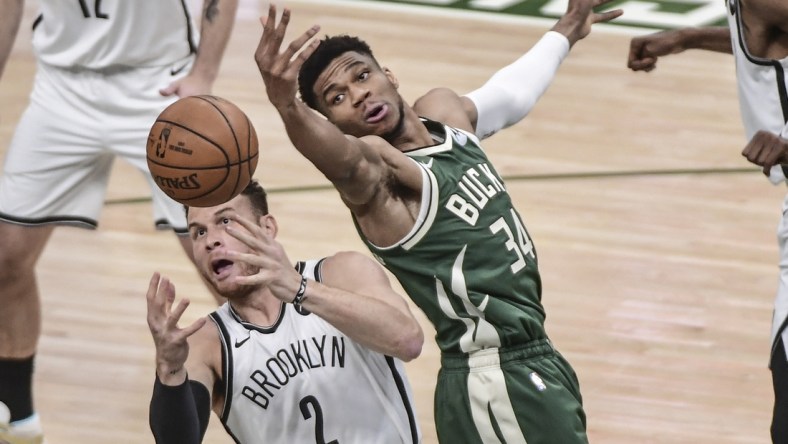 Jun 10, 2021; Milwaukee, Wisconsin, USA; Milwaukee Bucks forward Giannis Antetokounmpo (34) and Brooklyn Nets forward Blake Griffin (2) reach for a rebound in the first quarter during game three in the second round of the 2021 NBA Playoffs at Fiserv Forum. Mandatory Credit: Benny Sieu-USA TODAY Sports