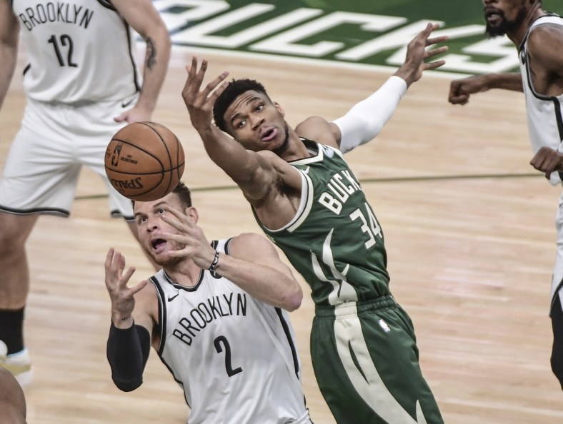 Jun 10, 2021; Milwaukee, Wisconsin, USA; Milwaukee Bucks forward Giannis Antetokounmpo (34) and Brooklyn Nets forward Blake Griffin (2) reach for a rebound in the first quarter during game three in the second round of the 2021 NBA Playoffs at Fiserv Forum. Mandatory Credit: Benny Sieu-USA TODAY Sports