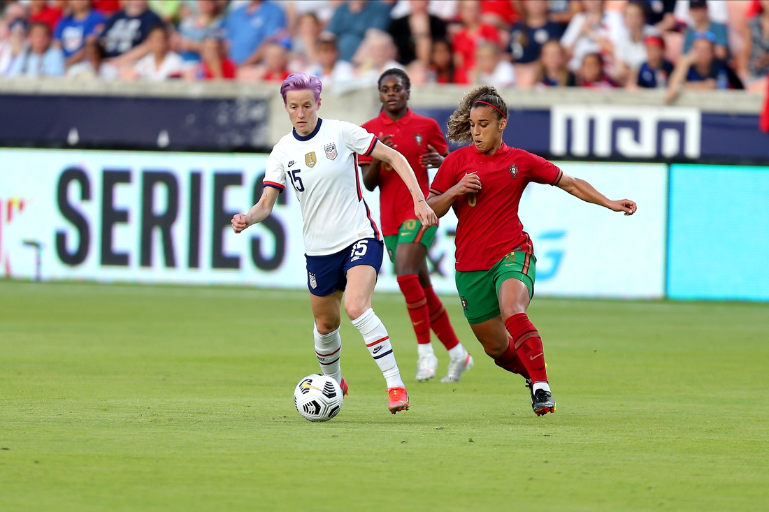 Jun 10, 2021; Houston, Texas, USA; United States forward Megan Rapinoe (15) advances the ball upfield while Portugal midfielder Andreia Jacinto (6) defends during the first half of a WNT Summer Series international friendly soccer match at BBVA Stadium. Mandatory Credit: Erik Williams-USA TODAY Sports