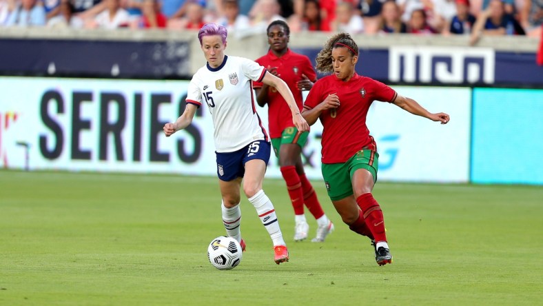 Jun 10, 2021; Houston, Texas, USA; United States forward Megan Rapinoe (15) advances the ball upfield while Portugal midfielder Andreia Jacinto (6) defends during the first half of a WNT Summer Series international friendly soccer match at BBVA Stadium. Mandatory Credit: Erik Williams-USA TODAY Sports