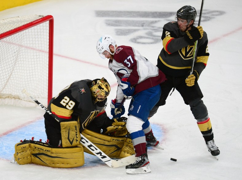 Jun 10, 2021; Las Vegas, Nevada, USA; Vegas Golden Knights goaltender Marc-Andre Fleury (29) defends the goal against Colorado Avalanche left wing J.T. Compher (37) as defenseman Zach Whitecloud (2) helps defend during the second period in game six of the second round of the 2021 Stanley Cup Playoffs at T-Mobile Arena. Mandatory Credit: Gary A. Vasquez-USA TODAY Sports