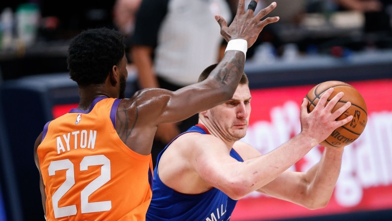 Jun 11, 2021; Denver, Colorado, USA; Denver Nuggets center Nikola Jokic (right) controls the ball while defended by Phoenix Suns center Deandre Ayton (22) in the third quarter during game three in the second round of the 2021 NBA Playoffs at Ball Arena. Mandatory Credit: Isaiah J. Downing-USA TODAY Sports