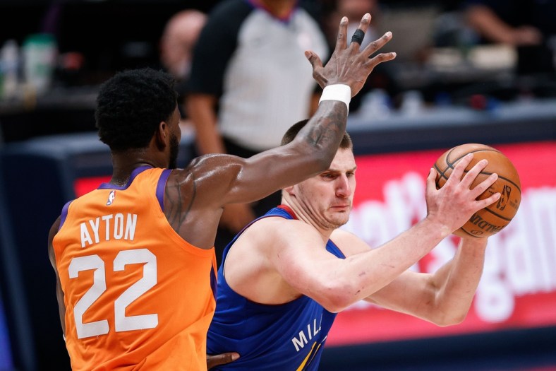 Jun 11, 2021; Denver, Colorado, USA; Denver Nuggets center Nikola Jokic (right) controls the ball while defended by Phoenix Suns center Deandre Ayton (22) in the third quarter during game three in the second round of the 2021 NBA Playoffs at Ball Arena. Mandatory Credit: Isaiah J. Downing-USA TODAY Sports