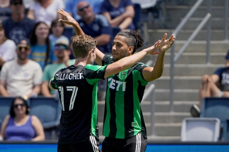 Jun 12, 2021; Kansas City, Kansas, USA; Austin FC forward Cecilio Dominguez (10) celebrates with forward Jon Gallagher (17) after scoring a goal against Sporting Kansas City during the first half of the match at Children's Mercy Park. Mandatory Credit: Denny Medley-USA TODAY Sports