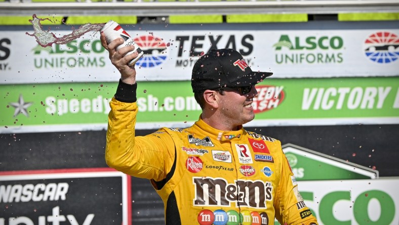 Jun 12, 2021; Fort Worth, TX, USA; NASCAR Xfinity Series driver Kyle Busch (54) celebrates in victory lane after he wins the Alsco Uniforms 250 race at Texas Motor Speedway. Mandatory Credit: Jerome Miron-USA TODAY Sports