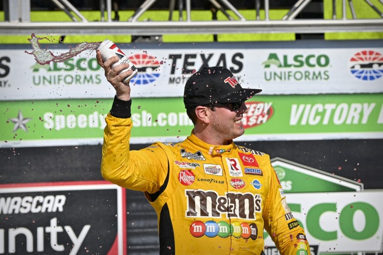 Jun 12, 2021; Fort Worth, TX, USA; NASCAR Xfinity Series driver Kyle Busch (54) celebrates in victory lane after he wins the Alsco Uniforms 250 race at Texas Motor Speedway. Mandatory Credit: Jerome Miron-USA TODAY Sports
