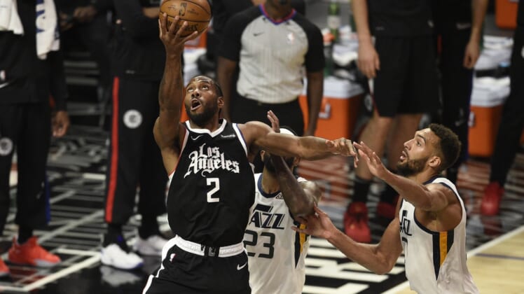 Jun 12, 2021; Los Angeles, California, USA; LA Clippers forward Kawhi Leonard (2) shoots the ball in front of Utah Jazz forward Royce O'Neale (23) and center Rudy Gobert (27) in the third quarter during game three in the second round of the 2021 NBA Playoffs. at Staples Center. Mandatory Credit: Kelvin Kuo-USA TODAY Sports