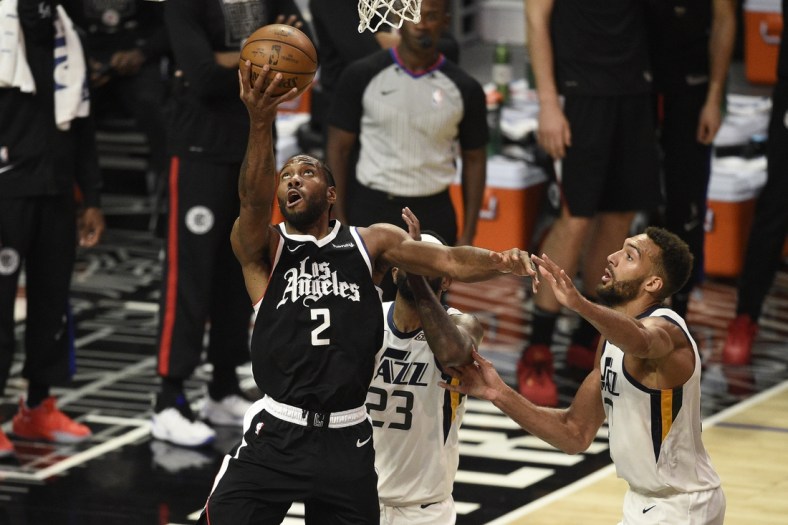 Jun 12, 2021; Los Angeles, California, USA; LA Clippers forward Kawhi Leonard (2) shoots the ball in front of Utah Jazz forward Royce O'Neale (23) and center Rudy Gobert (27) in the third quarter during game three in the second round of the 2021 NBA Playoffs. at Staples Center. Mandatory Credit: Kelvin Kuo-USA TODAY Sports