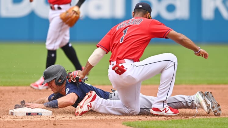 Jun 13, 2021; Cleveland, Ohio, USA; Seattle Mariners second baseman Dylan Moore (25) is caught stealing by Cleveland Indians shortstop Amed Rosario (1) during the third inning at Progressive Field. Mandatory Credit: Ken Blaze-USA TODAY Sports