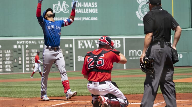 Jun 13, 2021; Boston, Massachusetts, USA; Toronto Blue Jays left fielder Lourdes Gurriel Jr. (13) reacts to hitting a home run as he approaches home plate during the first inning against the Boston Red Sox at Fenway Park. Mandatory Credit: Gregory Fisher-USA TODAY Sports
