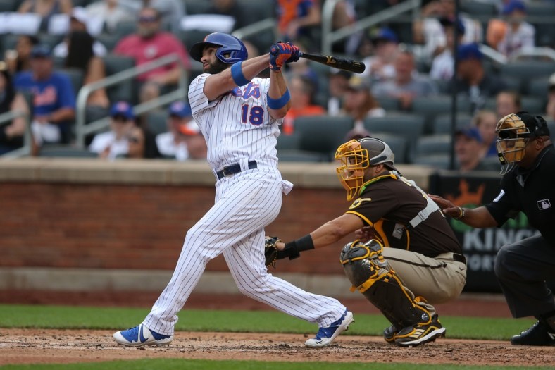 Jun 13, 2021; New York City, New York, USA; New York Mets second baseman Jose Peraza (18) follows through on a two run home run against the San Diego Padres during the fifth inning at Citi Field. Mandatory Credit: Brad Penner-USA TODAY Sports