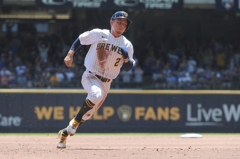 Jun 13, 2021; Milwaukee, Wisconsin, USA; Milwaukee Brewers third baseman Luis Urias (2) rounds second base to score a run against the Pittsburgh Pirates in the first inning at American Family Field. Mandatory Credit: Michael McLoone-USA TODAY Sports