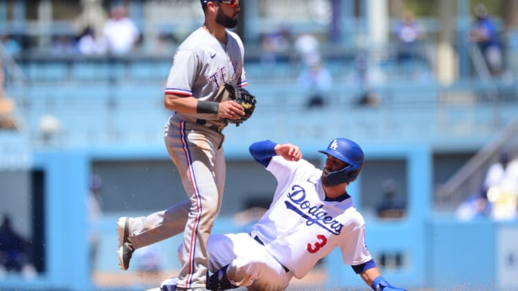 Jun 13, 2021; Los Angeles, California, USA; Los Angeles Dodgers second baseman Chris Taylor (3) reaches second against Texas Rangers shortstop Isiah Kiner-Falefa (9) during the third inning at Dodger Stadium. Mandatory Credit: Gary A. Vasquez-USA TODAY Sports
