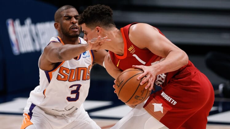 Jun 13, 2021; Denver, Colorado, USA; Denver Nuggets forward Michael Porter Jr. (1) controls the ball as Phoenix Suns guard Chris Paul (3) defends in the second quarter during game four in the second round of the 2021 NBA Playoffs at Ball Arena. Mandatory Credit: Isaiah J. Downing-USA TODAY Sports