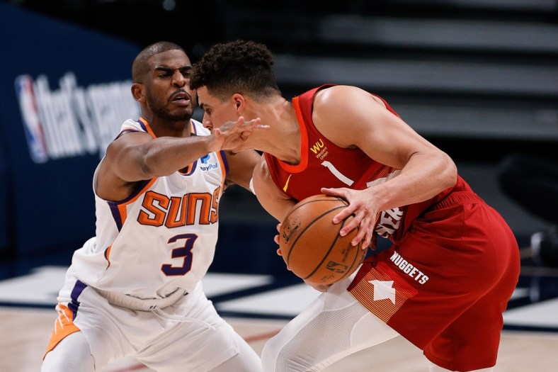 Jun 13, 2021; Denver, Colorado, USA; Denver Nuggets forward Michael Porter Jr. (1) controls the ball as Phoenix Suns guard Chris Paul (3) defends in the second quarter during game four in the second round of the 2021 NBA Playoffs at Ball Arena. Mandatory Credit: Isaiah J. Downing-USA TODAY Sports
