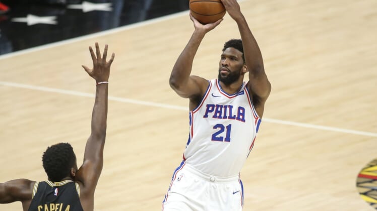 Jun 14, 2021; Atlanta, Georgia, USA; Philadelphia 76ers center Joel Embiid (21) shoots over Atlanta Hawks center Clint Capela (15) in the first quarter during game four in the second round of the 2021 NBA Playoffs at State Farm Arena. Mandatory Credit: Brett Davis-USA TODAY Sports