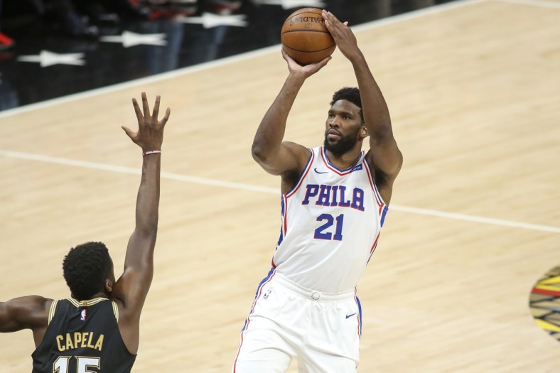 Jun 14, 2021; Atlanta, Georgia, USA; Philadelphia 76ers center Joel Embiid (21) shoots over Atlanta Hawks center Clint Capela (15) in the first quarter during game four in the second round of the 2021 NBA Playoffs at State Farm Arena. Mandatory Credit: Brett Davis-USA TODAY Sports