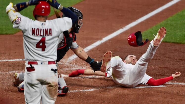 Jun 14, 2021; St. Louis, Missouri, USA;  St. Louis Cardinals center fielder Dylan Carlson (3) is tagged out at home by Miami Marlins catcher Jorge Alfaro (38) as catcher Yadier Molina (4) reacts during the third inning at Busch Stadium. Mandatory Credit: Jeff Curry-USA TODAY Sports