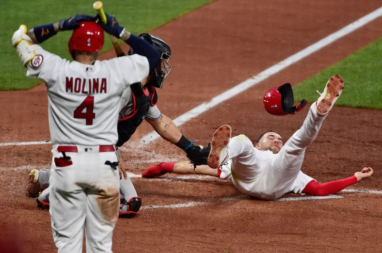 Jun 14, 2021; St. Louis, Missouri, USA;  St. Louis Cardinals center fielder Dylan Carlson (3) is tagged out at home by Miami Marlins catcher Jorge Alfaro (38) as catcher Yadier Molina (4) reacts during the third inning at Busch Stadium. Mandatory Credit: Jeff Curry-USA TODAY Sports