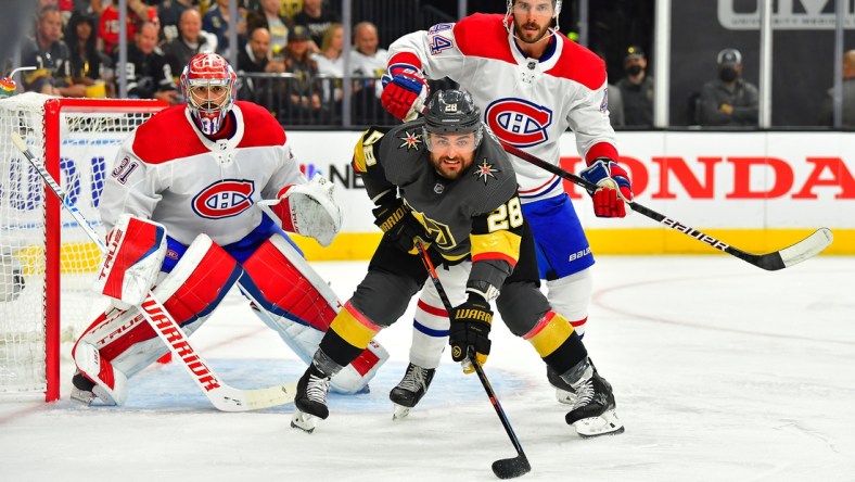 Jun 14, 2021; Las Vegas, Nevada, USA; Montreal Canadiens defenseman Joel Edmundson (44) checks Vegas Golden Knights left wing William Carrier (28) as Montreal Canadiens goaltender Carey Price (31) defends his goal during the first period of game one of the 2021 Stanley Cup Semifinals at T-Mobile Arena. Mandatory Credit: Stephen R. Sylvanie-USA TODAY Sports