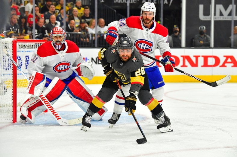 Jun 14, 2021; Las Vegas, Nevada, USA; Montreal Canadiens defenseman Joel Edmundson (44) checks Vegas Golden Knights left wing William Carrier (28) as Montreal Canadiens goaltender Carey Price (31) defends his goal during the first period of game one of the 2021 Stanley Cup Semifinals at T-Mobile Arena. Mandatory Credit: Stephen R. Sylvanie-USA TODAY Sports