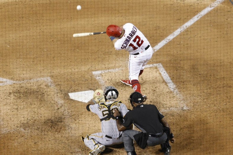 Jun 14, 2021; Washington, District of Columbia, USA; Washington Nationals left fielder Kyle Schwarber (12) hits a solo home run against the Pittsburgh Pirates in the seventh inning at Nationals Park. Mandatory Credit: Geoff Burke-USA TODAY Sports