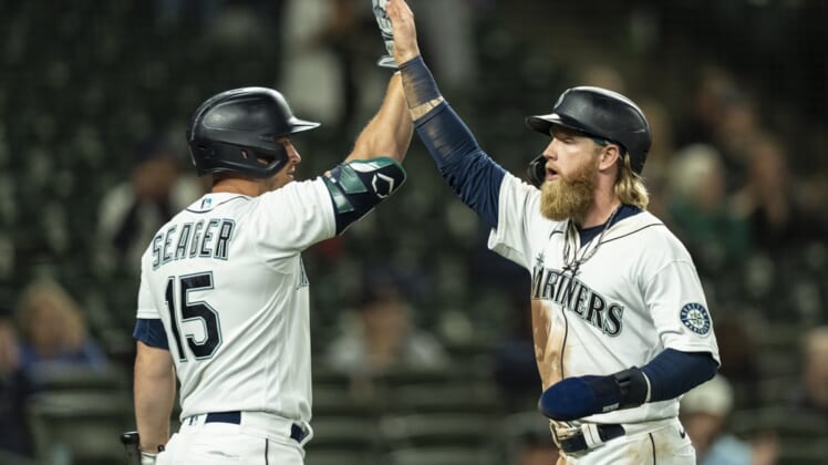 Jun 14, 2021; Seattle, Washington, USA; Seattle Mariners designated hitter Jake Fraley (28) is congratulated by third baseman Kyle Seager (15) after scoring a run on a double by first baseman Ty France (23) off of Minnesota Twins relief pitcher Luke Farrell (51) during the fifth inning of a game at T-Mobile Park. Mandatory Credit: Stephen Brashear-USA TODAY Sports