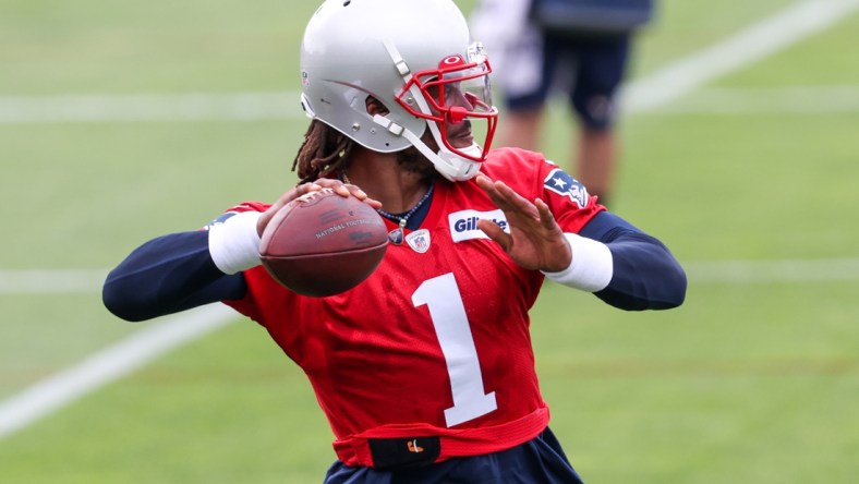 Jun 15, 2021; Foxborough, MA, USA; New England Patriots quarterback Cam Newton (1) participates in a drill during the New England Patriots mini camp at the New England Patriots practice complex. Mandatory Credit: Paul Rutherford-USA TODAY Sports