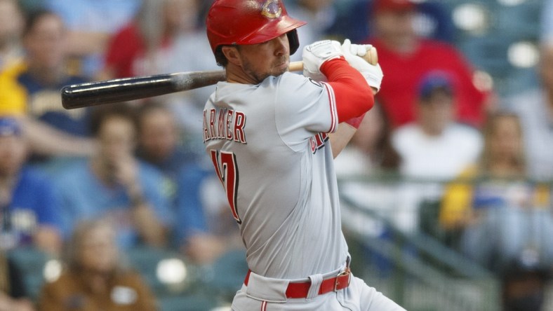 Jun 15, 2021; Milwaukee, Wisconsin, USA;  Cincinnati Reds second baseman Kyle Farmer (17) singles during the third inning against the Milwaukee Brewers at American Family Field. Mandatory Credit: Jeff Hanisch-USA TODAY Sports