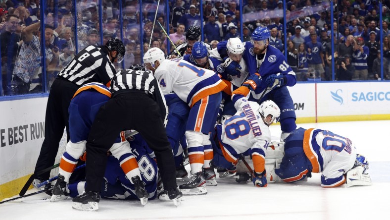 Jun 15, 2021; Tampa, Florida, USA; Tampa Bay Lightning center Brayden Point (21) gets pushes onto New York Islanders goaltender Semyon Varlamov (40) and teammates fight during the first period in game two of the 2021 Stanley Cup Semifinals at Amalie Arena. Mandatory Credit: Kim Klement-USA TODAY Sports