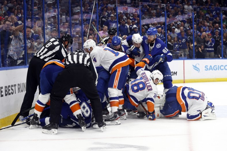 Jun 15, 2021; Tampa, Florida, USA; Tampa Bay Lightning center Brayden Point (21) gets pushes onto New York Islanders goaltender Semyon Varlamov (40) and teammates fight during the first period in game two of the 2021 Stanley Cup Semifinals at Amalie Arena. Mandatory Credit: Kim Klement-USA TODAY Sports
