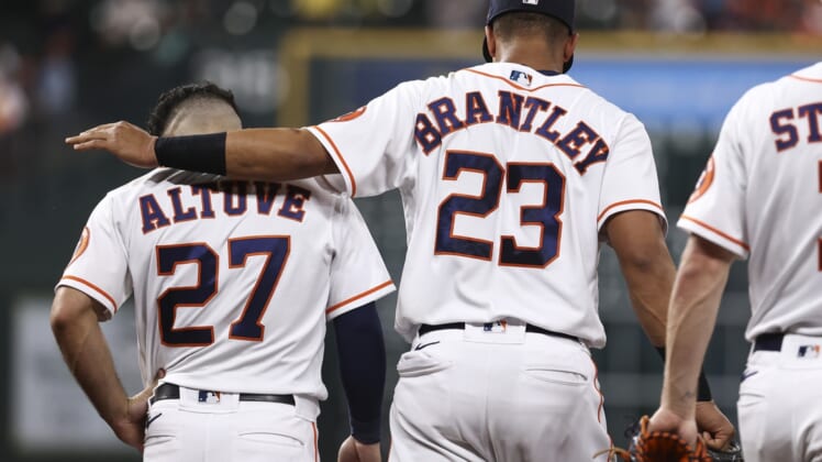 Jun 15, 2021; Houston, Texas, USA; Houston Astros left fielder Michael Brantley (23) talks with second baseman Jose Altuve (27) after a play during the third inning against the Texas Rangers at Minute Maid Park. Mandatory Credit: Troy Taormina-USA TODAY Sports