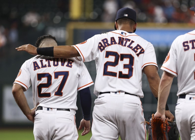 Jun 15, 2021; Houston, Texas, USA; Houston Astros left fielder Michael Brantley (23) talks with second baseman Jose Altuve (27) after a play during the third inning against the Texas Rangers at Minute Maid Park. Mandatory Credit: Troy Taormina-USA TODAY Sports