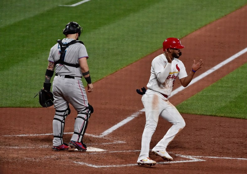 Jun 15, 2021; St. Louis, Missouri, USA;  St. Louis Cardinals pinch hitter Jose Rondon (64) celebrates after scoring the game tying run on a single by first baseman Paul Goldschmidt (not pictured) during the sixth inning against the Miami Marlins at Busch Stadium. Mandatory Credit: Jeff Curry-USA TODAY Sports