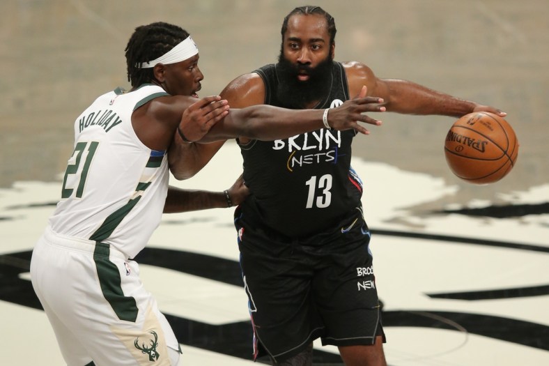 Jun 15, 2021; Brooklyn, New York, USA; Brooklyn Nets shooting guard James Harden (13) controls the ball against Milwaukee Bucks point guard Jrue Holiday (21) during the third quarter of game five of the second round of the 2021 NBA Playoffs at Barclays Center. Mandatory Credit: Brad Penner-USA TODAY Sports