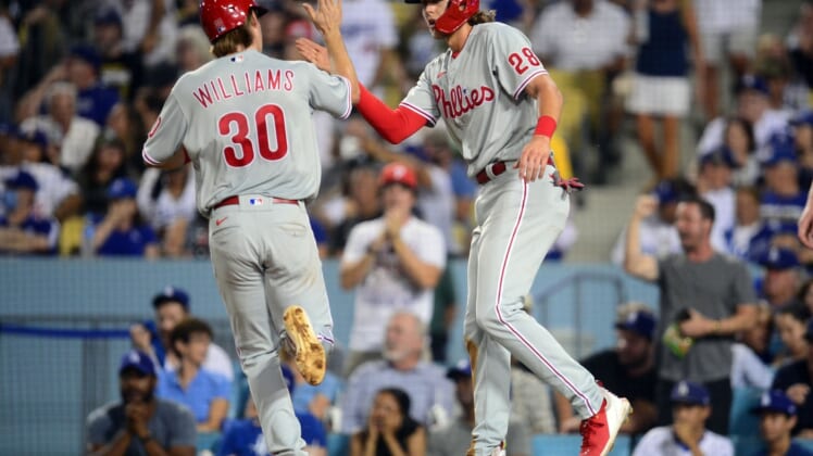 Jun 15, 2021; Los Angeles, California, USA; Philadelphia Phillies third baseman Alec Bohm (28) greets shortstop Luke Williams (30) after both score runs against the Los Angeles Dodgers during the fifth inning at Dodger Stadium. Mandatory Credit: Gary A. Vasquez-USA TODAY Sports