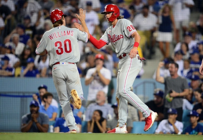 Jun 15, 2021; Los Angeles, California, USA; Philadelphia Phillies third baseman Alec Bohm (28) greets shortstop Luke Williams (30) after both score runs against the Los Angeles Dodgers during the fifth inning at Dodger Stadium. Mandatory Credit: Gary A. Vasquez-USA TODAY Sports