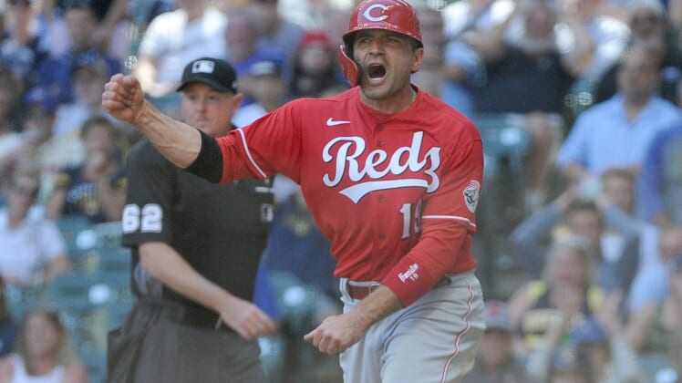 Jun 16, 2021; Milwaukee, Wisconsin, USA;  Cincinnati Reds first baseman Joey Votto (19) yells in celebration after scoring a run against the Milwaukee Brewers in the seventh inning at American Family Field. Mandatory Credit: Michael McLoone-USA TODAY Sports