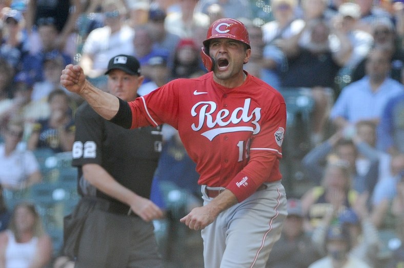 Jun 16, 2021; Milwaukee, Wisconsin, USA;  Cincinnati Reds first baseman Joey Votto (19) yells in celebration after scoring a run against the Milwaukee Brewers in the seventh inning at American Family Field. Mandatory Credit: Michael McLoone-USA TODAY Sports