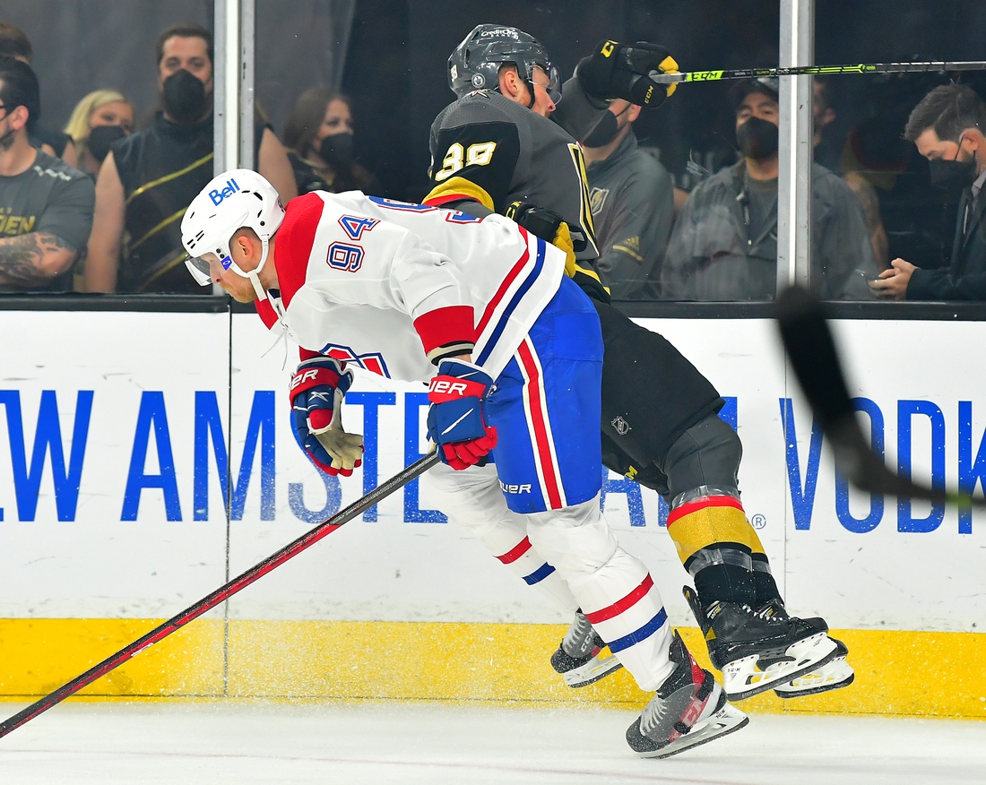 Jun 16, 2021; Las Vegas, Nevada, USA; Montreal Canadiens right wing Corey Perry (94) hip checks Vegas Golden Knights center Patrick Brown (38) during the first period of game two of the 2021 Stanley Cup Semifinals at T-Mobile Arena. Mandatory Credit: Stephen R. Sylvanie-USA TODAY Sports