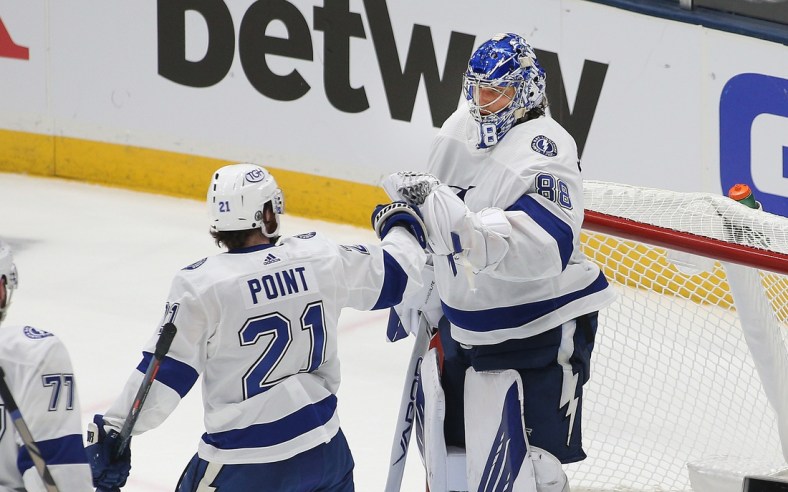 Jun 17, 2021; Uniondale, New York, USA; Tampa Bay Lightning goaltender Andrei Vasilevskiy (88) is congratulated by center Brayden Point (21) after defeating the New York Islanders during game three of the 2021 Stanley Cup Semifinals at Nassau Veterans Memorial Coliseum. Mandatory Credit: Andy Marlin-USA TODAY Sports