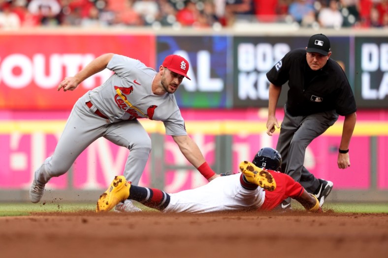 Jun 18, 2021; Atlanta, Georgia, USA; St. Louis Cardinals shortstop Paul DeJong (11) tags out Atlanta Braves outfielder Ronald Acuna Jr. (13) on a stolen base attempt at second base during the first inning at Truist Park. Mandatory Credit: Jason Getz-USA TODAY Sports