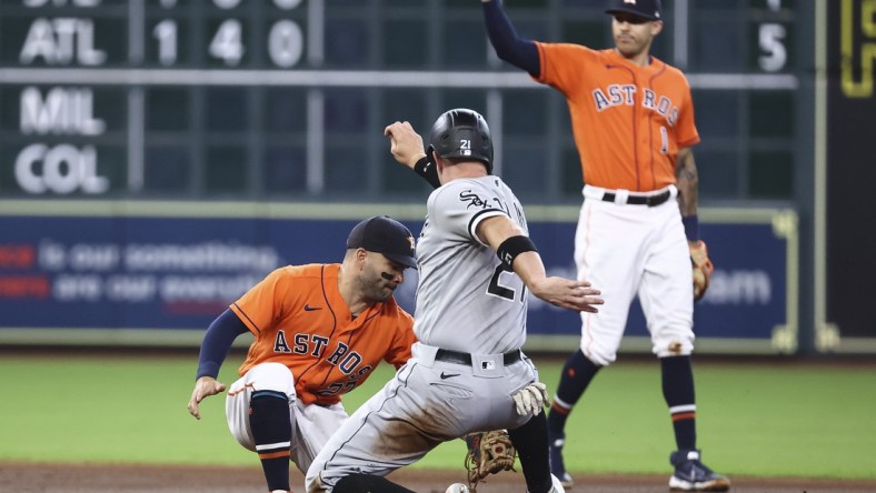 Jun 18, 2021; Houston, Texas, USA; Chicago White Sox catcher Zack Collins (21) is tagged out on a stolen base attempt by Houston Astros second baseman Jose Altuve (27) during the second inning at Minute Maid Park. Mandatory Credit: Troy Taormina-USA TODAY Sports