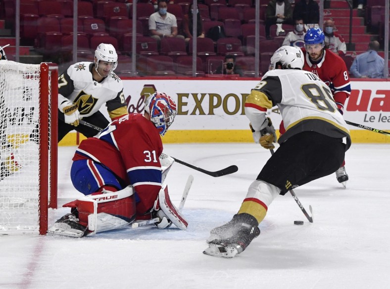 Jun 18, 2021; Montreal, Quebec, CAN; Montreal Canadiens goalie Carey Price (31) stops Vegas Golden Knights forward Jonathan Marchessault (81) and teammate forward Max Pacioretty (67) during the first period in game three of the 2021 Stanley Cup Semifinals at the Bell Centre. Mandatory Credit: Eric Bolte-USA TODAY Sports